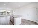 Kitchen island featuring a stainless steel sink and granite countertops, with large windows at 22133 E 38Th Pl, Aurora, CO 80019