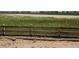 View from the backyard of an unfinished property with a wooden fence at 418 Grey Rock St, Brighton, CO 80601