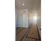 Bright hallway featuring white walls and neutral flooring that leads to the rest of the home at 418 Grey Rock St, Brighton, CO 80601
