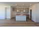Bright kitchen featuring pendant lighting, an island, and modern cabinets at 418 Grey Rock St, Brighton, CO 80601