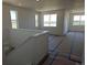 Spacious living room with lots of windows, new paint, and natural light at 418 Grey Rock St, Brighton, CO 80601