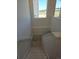A clean and simple staircase featuring white walls and lots of light from nearby windows at 418 Grey Rock St, Brighton, CO 80601