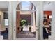 Charming courtyard view through arched doorways; bedroom with red wall is visible to the right at 400 S Steele St # 64, Denver, CO 80209