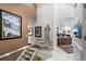 Grand entryway showcasing a glass staircase and art-filled walls leading to the kitchen at 400 S Steele St # 64, Denver, CO 80209