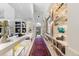 Bright hallway with art displays and custom shelving, leading to a view of the backyard patio at 400 S Steele St # 64, Denver, CO 80209