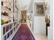 Inviting hallway showcases a long bookshelf and bright lighting, creating an elegant and functional space at 400 S Steele St # 64, Denver, CO 80209