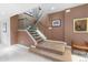 A carpeted staircase with glass railing enhances the home's interior with modern design elements at 400 S Steele St # 64, Denver, CO 80209