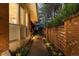 Charming walkway with stone pavers, accent lighting, and a beautiful brick retaining wall leads to a serene outdoor patio at 400 S Steele St # 64, Denver, CO 80209