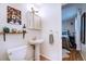 Cozy half bathroom boasts neutral decor and unique art at 855 33Rd St, Boulder, CO 80303