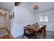 Charming dining room with a rustic wooden table, stylish chairs, wainscoting, and modern lighting at 855 33Rd St, Boulder, CO 80303