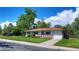 Inviting ranch-style home with a brick facade, attached garage, and lush green lawn on a bright, clear day at 855 33Rd St, Boulder, CO 80303