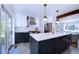 Modern kitchen with stainless steel appliances, white subway tile backsplash, and a large center island at 855 33Rd St, Boulder, CO 80303