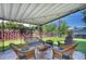 Relaxing outdoor living space with wicker seating, a fire pit, and charming string lights overhead at 855 33Rd St, Boulder, CO 80303