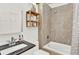 Bathroom featuring a tub-shower combo with tile surround, wood shelves, and modern vanity at 3030 W Prentice Ave # D, Littleton, CO 80123