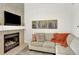 Bright living room with fireplace and mounted TV at 3030 W Prentice Ave # D, Littleton, CO 80123