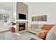 Cozy living room featuring a tiled fireplace with mounted TV at 3030 W Prentice Ave # D, Littleton, CO 80123