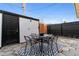Backyard patio features a stone patio, black metal furniture and a black and white outdoor rug at 12708 W Virginia Ave, Lakewood, CO 80228
