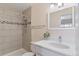 Updated bathroom with modern fixtures, tiled shower, and a sleek vanity with great lighting at 12708 W Virginia Ave, Lakewood, CO 80228