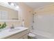 Bright bathroom featuring a white vanity, tub-shower combination, and white tile at 12708 W Virginia Ave, Lakewood, CO 80228