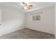 Cozy bedroom with carpet flooring, a window, and a ceiling fan providing comfort and natural light at 12708 W Virginia Ave, Lakewood, CO 80228