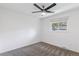 Neutral bedroom features a ceiling fan, window bringing in natural light and carpeting at 12708 W Virginia Ave, Lakewood, CO 80228