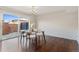 Light-filled dining room with modern chandelier, glass-top table, and sliding glass door to the outdoors at 12708 W Virginia Ave, Lakewood, CO 80228