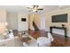 Spacious living room with an updated ceiling fan, adjacent to a carpeted staircase at 12708 W Virginia Ave, Lakewood, CO 80228
