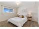 Serene bedroom with a plush bed, carpeted floors, and natural light from the window at 12708 W Virginia Ave, Lakewood, CO 80228