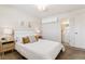 Cozy main bedroom featuring plush bedding, neutral decor, and an attached bathroom for added convenience at 12708 W Virginia Ave, Lakewood, CO 80228
