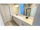 Bright bathroom featuring double sinks, and a glass enclosed shower at 2263 Serenidad St, Brighton, CO 80601