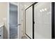 Modern bathroom with white tiled shower and sleek black frame at 2263 Serenidad St, Brighton, CO 80601