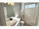 Bright bathroom featuring a shower over tub, neutral-toned walls and vanity with black hardware at 2263 Serenidad St, Brighton, CO 80601