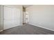 Bedroom with gray carpet and white closet doors at 2263 Serenidad St, Brighton, CO 80601