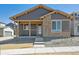 Charming single-story home featuring stone accents and a covered front porch at 2263 Serenidad St, Brighton, CO 80601