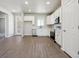 Well-lit kitchen featuring stainless steel appliances and white cabinetry at 2263 Serenidad St, Brighton, CO 80601