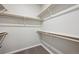 Walk-in closet with carpet and wooden shelf and rail system at 2263 Serenidad St, Brighton, CO 80601