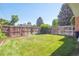 Spacious backyard with a well-maintained lawn and a sturdy wooden fence at 7351 S Sheridan Ct, Littleton, CO 80128