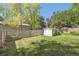 Well-maintained backyard features a wooden privacy fence, shed and lush green lawn at 7351 S Sheridan Ct, Littleton, CO 80128