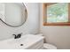 Modern bathroom featuring sleek fixtures, a large mirror, and a well-lit vanity at 7351 S Sheridan Ct, Littleton, CO 80128