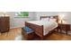 Bright bedroom with hardwood floors, large bed, and stylish wooden furniture at 7351 S Sheridan Ct, Littleton, CO 80128