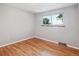 Bedroom with hardwood floors and a bright window offering natural light and neighborhood views at 7351 S Sheridan Ct, Littleton, CO 80128