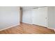Bright bedroom with hardwood floors and a double-door closet for convenient storage at 7351 S Sheridan Ct, Littleton, CO 80128