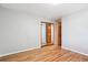Light-filled bedroom featuring hardwood floors and a mirrored closet for ample storage at 7351 S Sheridan Ct, Littleton, CO 80128