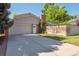 Home exterior features a two car garage, brick accents, and a long driveway at 7351 S Sheridan Ct, Littleton, CO 80128