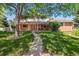 Charming brick home with a well-manicured lawn and inviting front porch at 7351 S Sheridan Ct, Littleton, CO 80128