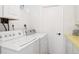 Functional laundry room equipped with a modern washer and dryer for convenience at 7351 S Sheridan Ct, Littleton, CO 80128