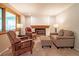 Cozy living room featuring a fireplace, comfortable seating, and a large window at 7351 S Sheridan Ct, Littleton, CO 80128