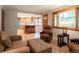 Inviting living room with light wood floors seamlessly flows into a bright kitchen with an island and modern features at 7351 S Sheridan Ct, Littleton, CO 80128