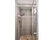 Modern shower featuring sleek gray tile, mosaic accents, and glass door at 7351 S Sheridan Ct, Littleton, CO 80128