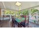 Bright sunroom with lots of windows with wood table and rug at 7351 S Sheridan Ct, Littleton, CO 80128